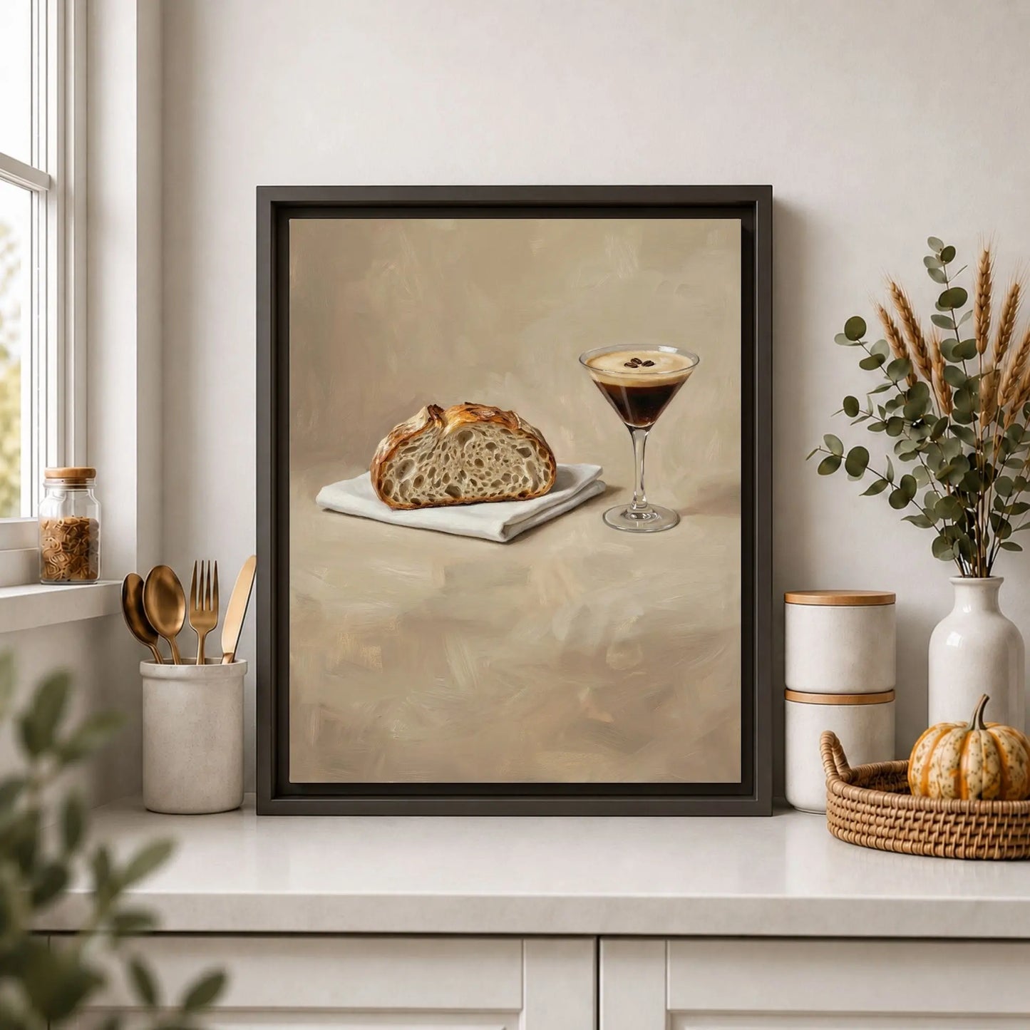 Framed artwork of a slice of sourdough bread and an espresso martini cocktail on a kitchen counter.