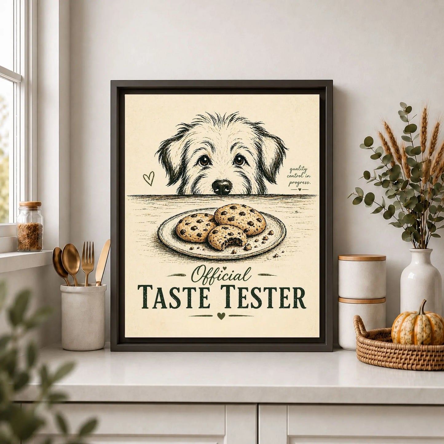 Framed print of a dog with cookies labeled 'Official Taste Tester' on a kitchen counter.