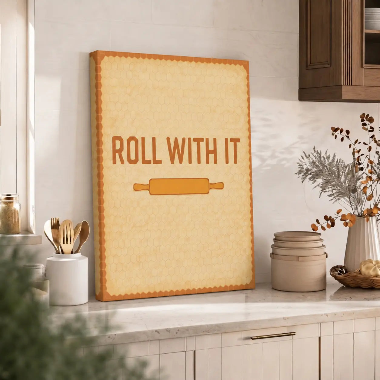Decorative wall art with 'Roll with It' text and rolling pin in a kitchen setting