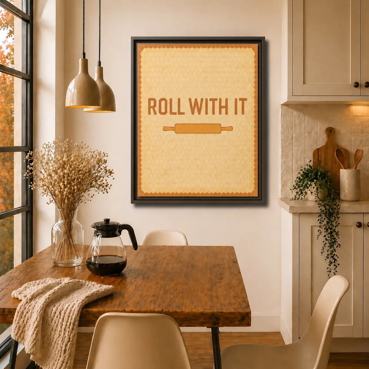 Kitchen interior with a framed kitchen wall art canvas reading 'Roll with It' above a wooden table.